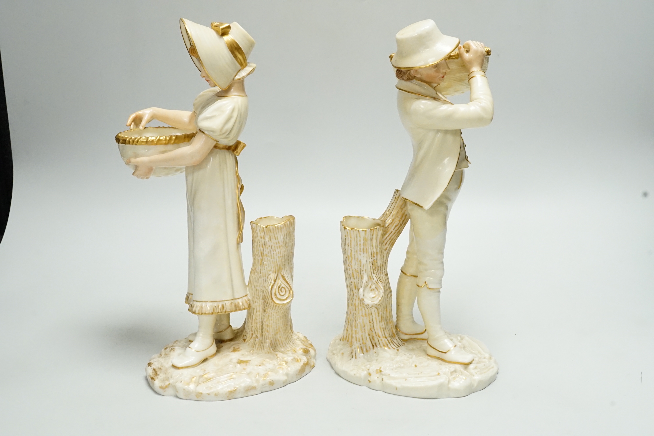 A pair of Worcester porcelain figures, modelled as a boy and girl with baskets, shape number 880, 26cm